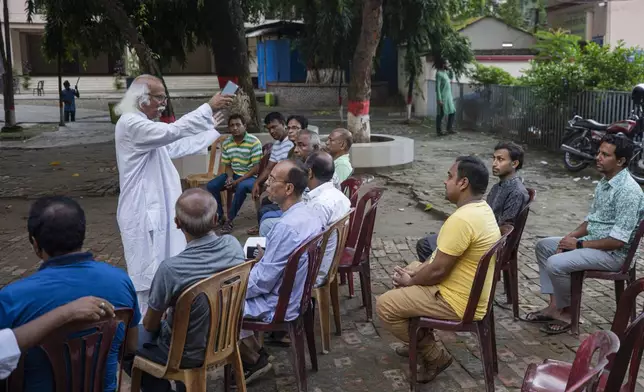 Kajol Debnath, left, president of Bangladesh Hindu Buddhist Christian Unity Council, talks to Hindu community leaders at Dhakeshwari National Temple in Dhaka, Bangladesh, Sunday, Aug.11, 2024. (AP Photo/Rajib Dhar)