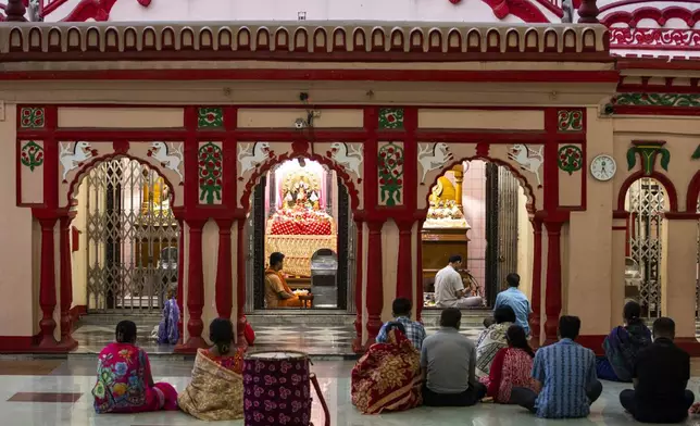 Hindu devotees pray at the Dhakeshwari National Temple in Dhaka, Bangladesh, Sunday, Aug.11, 2024. (AP Photo/Rajib Dhar)