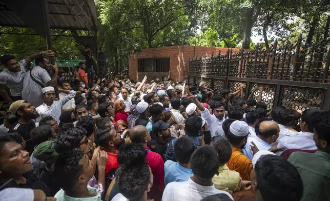 People crowd in front of the vandalised house of Sheikh Hasina, who resigned as Prime Minister on Monday, in Dhaka, Bangladesh, Tuesday, Aug. 6, 2024. (AP Photo/Rajib Dhar)