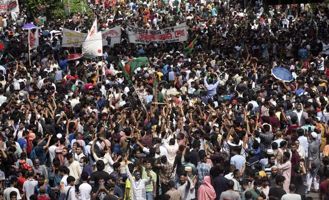 People shout slogans as they take part in a protest against Prime Minister Sheikh Hasina and her government demanding justice for the victims killed in the recent countrywide deadly clashes, in Dhaka, Bangladesh, Monday, Aug. 5, 2024. (AP Photo/Rajib Dhar)