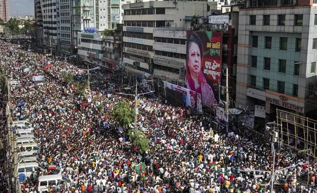 People gather in front of the Bangladesh Nationalist Party (BNP) headquarters during a protest rally in Dhaka, Bangladesh, Wednesday, Aug. 7, 2024. (AP Photo/Rajib Dhar)