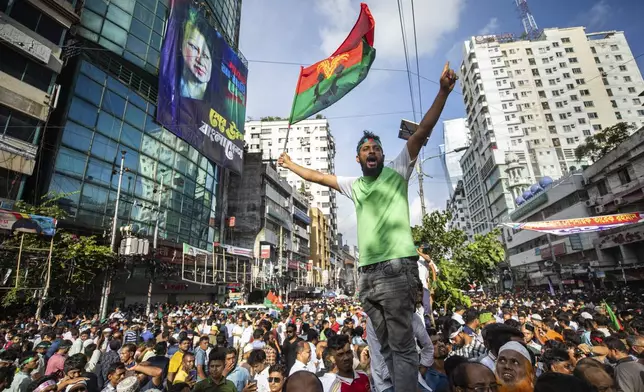 People gather in front of the Bangladesh Nationalist Party (BNP) headquarters during a protest rally in Dhaka, Bangladesh, Wednesday, Aug. 7, 2024. (AP Photo/Rajib Dhar)