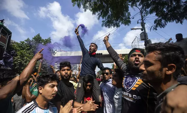 Protesters shout slogans as they celebrate after getting the news of Prime Minister Sheikh Hasina's resignation, in Dhaka, Bangladesh, Monday, Aug. 5, 2024. (AP Photo/Rajib Dhar)