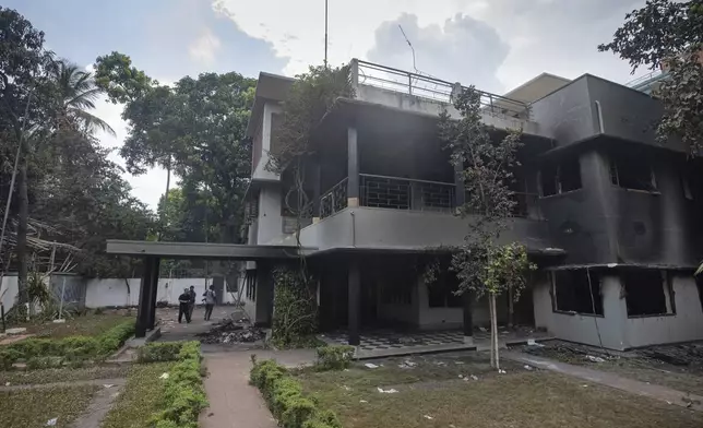 People visit the vandalised museum of Sheikh Mujibur Rahman, father of Sheikh Hasina who resigned as Prime Minister on Monday, in Dhaka, Bangladesh, Tuesday, Aug. 6, 2024. (AP Photo/Rajib Dhar)