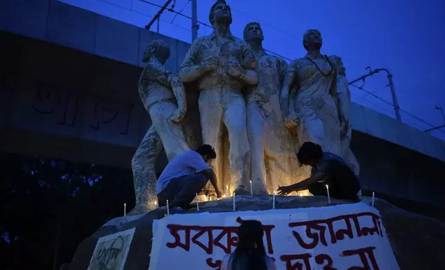 People participate in a candlelight vigil to pay tribute to victims of recent countrywide violence, in Dhaka, Bangladesh, Wednesday, Aug. 7, 2024. (AP Photo/Fatima Tuj Johora)