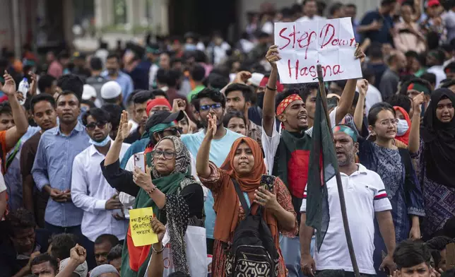 People shout slogans as they take part in a protest against Prime Minister Sheikh Hasina and her government demanding justice for the victims killed in the recent countrywide deadly clashes, in Dhaka, Bangladesh, Monday, Aug. 5, 2024. (AP Photo/Rajib Dhar)