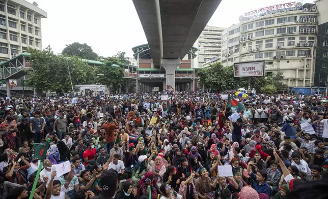 People shout slogans as they take part in a protest against Prime Minister Sheikh Hasina and her government demanding justice for the victims killed in the recent countrywide deadly clashes, in Dhaka, Bangladesh, Monday, Aug. 5, 2024. (AP Photo/Rajib Dhar)