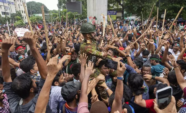 Protesters carry a member of the army on their shoulders as they celebrate Prime Minister Sheikh Hasina's resignation, in Dhaka, Bangladesh, Monday, Aug. 5, 2024. (AP Photo/Rajib Dhar)