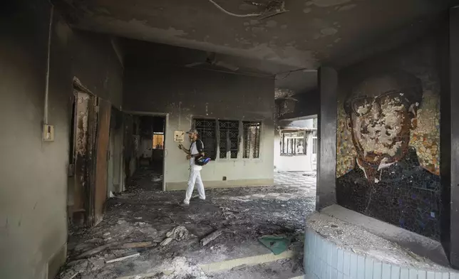 A man visits the vandalised museum of Sheikh Mujibur Rahman, father of Sheikh Hasina who resigned as Prime Minister on Monday, in Dhaka, Bangladesh, Tuesday, Aug. 6, 2024. (AP Photo/Rajib Dhar)