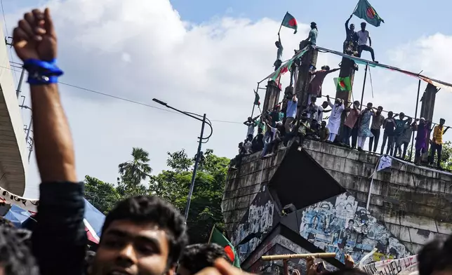 Protesters shout slogans as they celebrate Prime Minister Sheikh Hasina's resignation, in Dhaka, Bangladesh, Monday, Aug. 5, 2024. (AP Photo/Rajib Dhar)