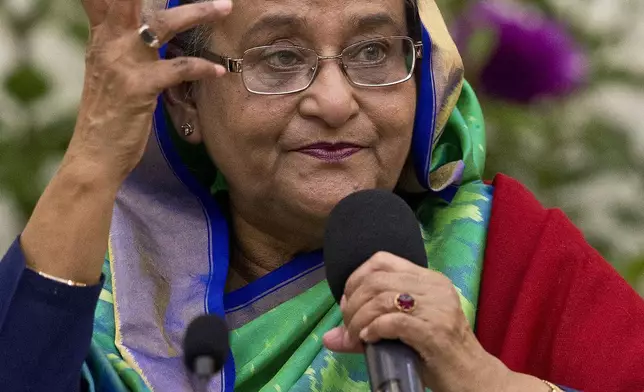 FILE- Bangladeshi Prime Minister Sheikh Hasina interacts with journalists in Dhaka, Bangladesh, Monday, Dec. 31, 2018. Protesters stormed Hasina’s official residence on Monday, Aug. 5, 2024, as leader’s whereabouts are unknown. (AP Photo/Anupam Nath, File)