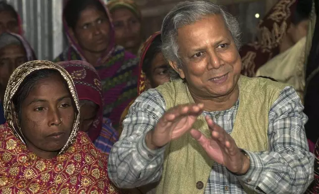 FILE- Professor Mohammed Yunus, founder of Grameen Bank, a micro credit institution, explains to villagers the benefits of the system at Kalampur village in Dhaka, Bangladesh, Jan. 21, 2004. (AP Photo/Pavel Rahman, File)