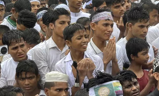 Rohingya refugees pray at a gathering to demand safe return to Myanmar's Rakhine state as they mark the seventh anniversary of their mass exodus from Myanmar at their refugee camp at Kutupalong in Cox's Bazar district, Bangladesh, Sunday, Aug. 25, 2024. (AP Photo/ Shafiqur Rahman)