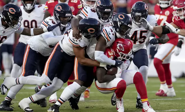 Kansas City Chiefs running back Deneric Prince (34) is stopped by a host of Chicago Bears players during the first half of an NFL preseason football game Thursday, Aug. 22, 2024, in Kansas City, Mo. (AP Photo/Ed Zurga)