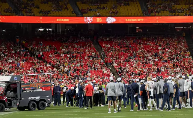 The Chicago Bears gather around teammate Douglas Coleman III as he is treated after being injured during the second half of a preseason NFL football game, Thursday, Aug. 22, 2024 in Kansas City, Mo. (AP Photo/Reed Hoffmann)