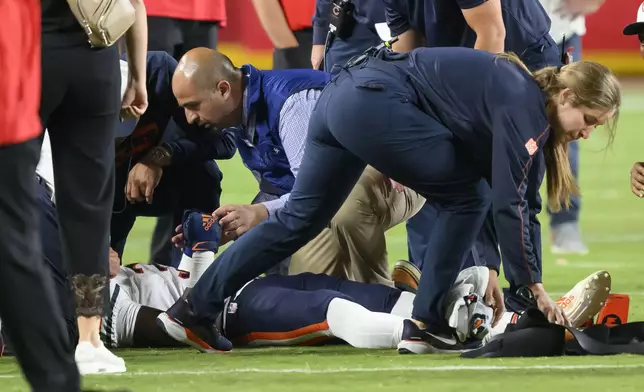 Chicago Bears safety Douglas Coleman III, bottom, is treated on the field after being injured during the second half of a preseason NFL football game against the Kansas City Chiefs, Thursday, Aug. 22, 2024 in Kansas City, Mo. (AP Photo/Reed Hoffmann)