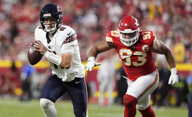 Chicago Bears quarterback Brett Rypien (11) scrambles as Kansas City Chiefs defensive tackle Matt Dickerson (93) defends during the first half of an NFL preseason football game Thursday, Aug. 22, 2024, in Kansas City, Mo. (AP Photo/Charlie Riedel)