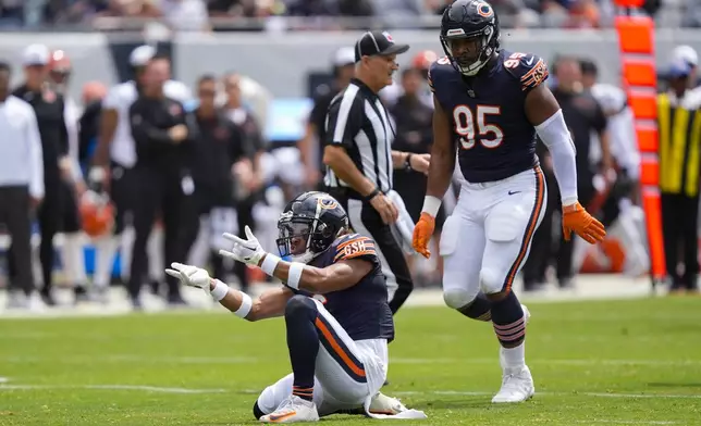 Chicago Bears cornerback Kyler Gordon (6) reacting after sacking Cincinnati Bengals quarterback Logan Woodside (11) during the first half of an NFL preseason football game, Saturday, Aug. 17, 2024, at Soldier Field in Chicago. Also on the field is Chicago Bears defensive end DeMarcus Walker (95). (AP Photo/Charles Rex Arbogast)