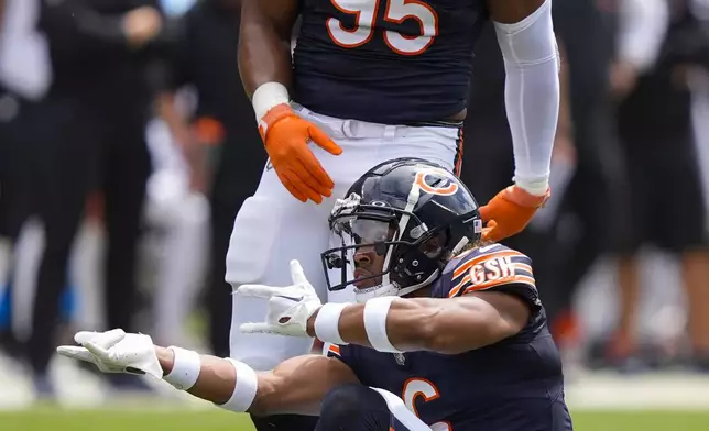 Chicago Bears cornerback Kyler Gordon (6) reacting after sacking Cincinnati Bengals quarterback Logan Woodside (11) during the first half of an NFL preseason football game, Saturday, Aug. 17, 2024, at Soldier Field in Chicago. Also on the field is Chicago Bears defensive end DeMarcus Walker (95). (AP Photo/Charles Rex Arbogast)