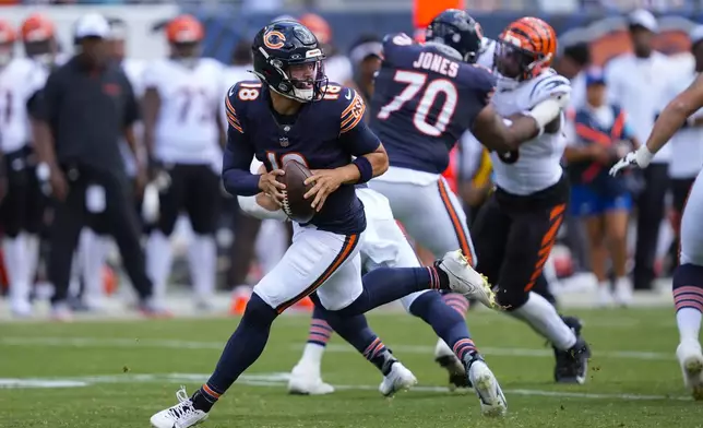 Chicago Bears quarterback Caleb Williams (18) scrambles out of the pocket during the first half of an NFL preseason football game against the Cincinnati Bengals, Saturday, Aug. 17, 2024, at Soldier Field in Chicago. (AP Photo/Charles Rex Arbogast)