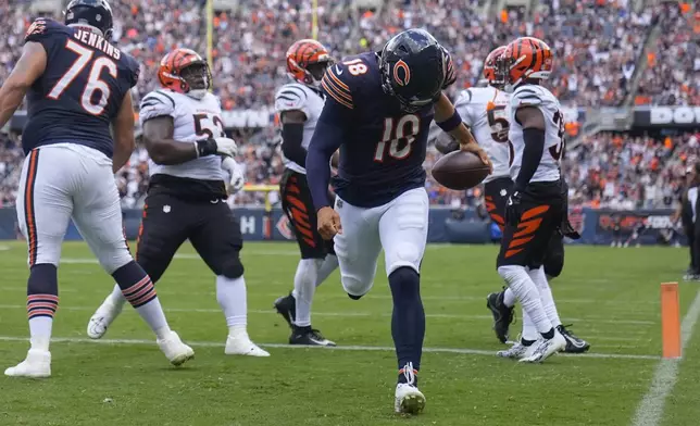 Chicago Bears quarterback Caleb Williams (18) carries the ball in for a touchdown during the first half of an NFL preseason football game against Cincinnati Bengals, Saturday, Aug. 17, 2024, at Soldier Field in Chicago. (AP Photo/Erin Hooley)