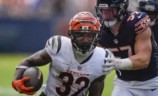 Cincinnati Bengals running back Trayveon Williams (32) runs with the ball against Chicago Bears linebacker Jack Sanborn (57) during the first half of an NFL preseason football game, Saturday, Aug. 17, 2024, at Soldier Field in Chicago. (AP Photo/Erin Hooley)