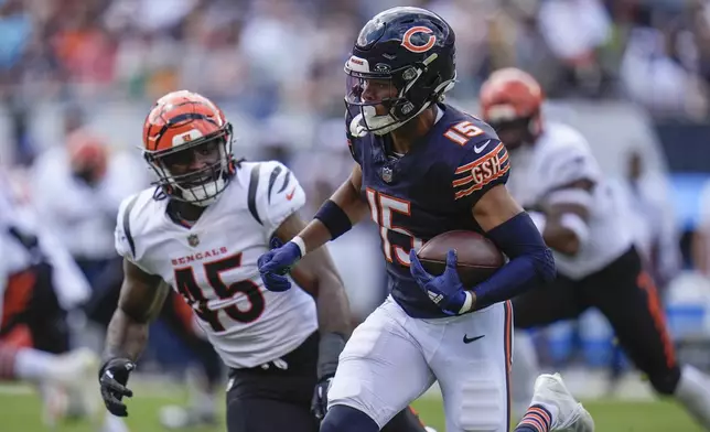 Chicago Bears wide receiver Rome Odunze (15) runs with the ball against Cincinnati Bengals linebacker Maema Njongmeta (45) during the first half of an NFL preseason football game, Saturday, Aug. 17, 2024, at Soldier Field in Chicago. (AP Photo/Erin Hooley)