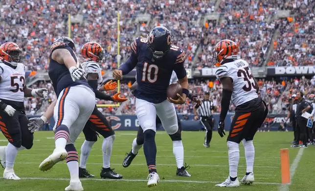 Chicago Bears quarterback Caleb Williams (18) carries the ball in for a touchdown during the first half of an NFL preseason football game against Cincinnati Bengals, Saturday, Aug. 17, 2024, at Soldier Field in Chicago. (AP Photo/Erin Hooley)