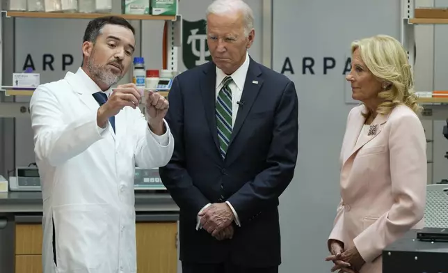 President Joe Biden and first lady Jill Biden listen during a demonstration of cancer research and detection techniques at Tulane University, Tuesday, Aug. 13, 2024, in New Orleans. (AP Photo/Mark Schiefelbein)