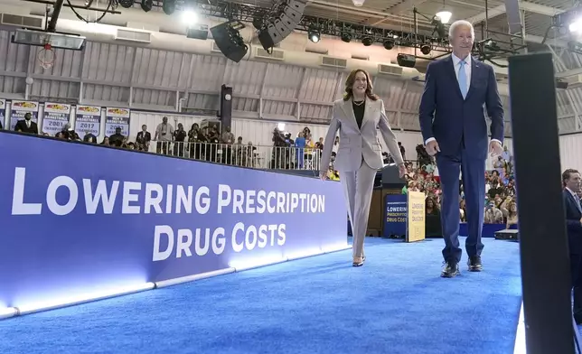 Democratic presidential nominee Vice President Kamala Harris, left, and President Joe Biden depart after speaking about the administration's efforts to lower prescription drug costs during an event at Prince George's Community College in Largo, Md., Thursday, Aug. 15, 2024. (AP Photo/Susan Walsh)