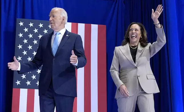 President Joe Biden, left, and Democratic presidential nominee Vice President Kamala Harris arrive to speak about the administration's efforts to lower costs during an event at Prince George's Community College in Largo, Md., Thursday, Aug. 15, 2024. (AP Photo/Susan Walsh)