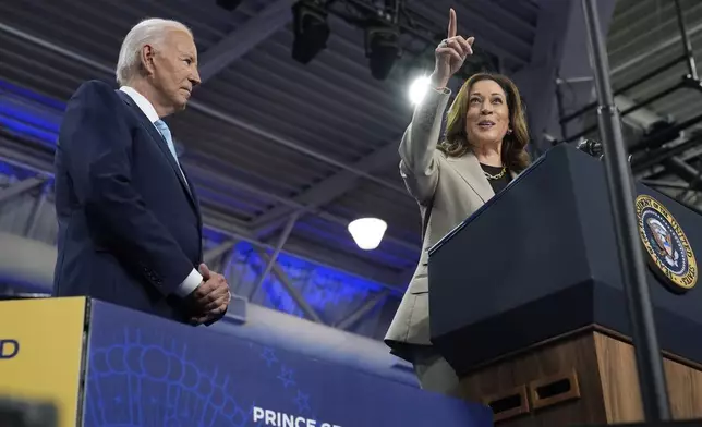 President Joe Biden, left, listens as Democratic presidential nominee Vice President Kamala Harris speaks about the administration's efforts to lower prescription drug costs during an event at Prince George's Community College in Largo, Md., Thursday, Aug. 15, 2024. (AP Photo/Susan Walsh)