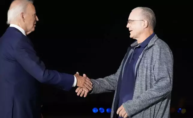 President Joe Biden, left, greets Paul Whelan at Andrews Air Force Base, Md., following his release as part of a 24-person prisoner swap between Russia and the United States, Thursday, Aug. 1, 2024. (AP Photo/Alex Brandon)