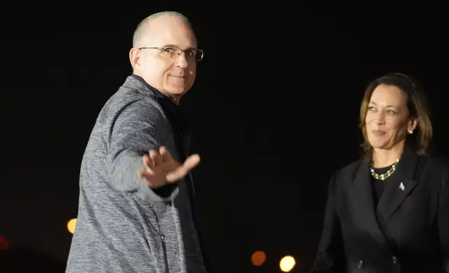 Vice President Kamala Harris, right, looks on at Paul Whelan at Andrews Air Force Base, Md., following his release as part of a 24-person prisoner swap between Russia and the United States, Thursday, Aug. 1, 2024. (AP Photo/Alex Brandon)