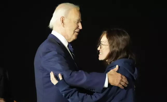 President Joe Biden, left, greets Alsu Kurmasheva at Andrews Air Force Base, Md., following her release as part of a 24-person prisoner swap between Russia and the United States, Thursday, Aug. 1, 2024. (AP Photo/Alex Brandon)