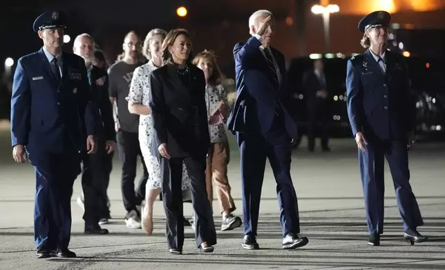 President Joe Biden, center right, and Vice President Kamala Harris, center left, walk to greet reporter Evan Gershkovich, Alsu Kurmasheva and Paul Whelan at Andrews Air Force Base, Md., following their release as part of a 24-person prisoner swap between Russia and the United States, Thursday, Aug. 1, 2024. (AP Photo/Alex Brandon)