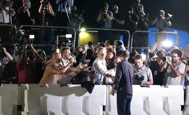 Reporter Evan Gershkovich greets colleagues at Andrews Air Force Base, Md., following his release as part of a 24-person prisoner swap between Russia and the United States, Thursday, Aug. 1, 2024. (AP Photo/Alex Brandon)