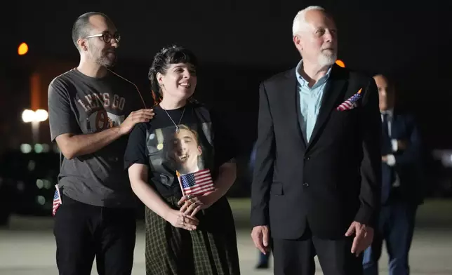 Family of Evan Gershkovich brother-in-law Anthony Huczek, from left, sister Danielle Gershkovich and father Mikhail Gershkovich, watch as President Joe Biden and Vice President Kamala Harris greet Gershkovich at Andrews Air Force Base, Md., following his release as part of a 24-person prisoner swap between Russia and the United States, Thursday, Aug. 1, 2024. (AP Photo/Alex Brandon)