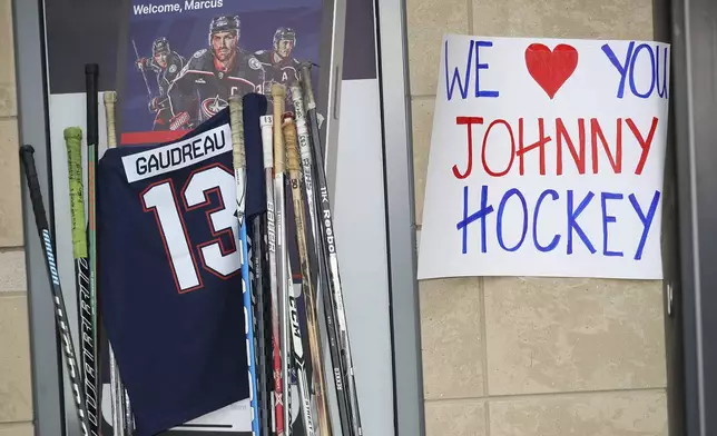 A memorial is set up by fans for Blue Jackets hockey player Johnny Gaudreau in Columbus, Ohio, Aug. 30, 2024. Gaudreau, along with his brother Matthew, was fatally struck by a motorist while riding his bicycle on Thursday. (AP Photo/Joe Maiorana)