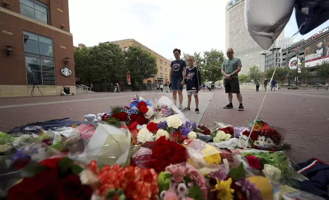 From left; Jamie, Gavin and John Rose pay their respects at a memorial set up by fans for Blue Jackets hockey player Johnny Gaudreau in Columbus, Ohio, Aug. 30, 2024. Gaudreau, along with his brother Matthew, was fatally struck by a motorist while riding his bicycle on Thursday. (AP Photo/Joe Maiorana)