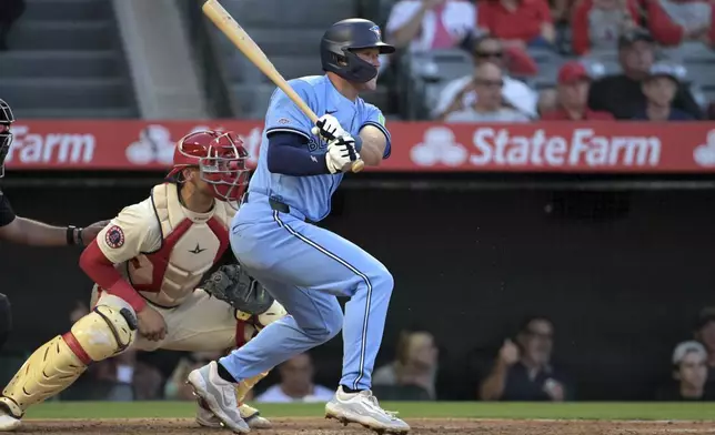 Toronto Blue Jays' Will Wagner, right, hits an RBI single during the third inning of a baseball game against the Los Angeles Angels, Monday, Aug. 12, 2024, in Anaheim, Calif. (AP Photo/Jayne-Kamin-Oncea)