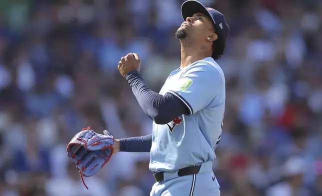 Toronto Blue Jays relief pitcher Génesis Cabrera reacts after striking out Chicago Cubs' Isaac Paredes during the eighth inning of a baseball game Sunday, Aug. 18, 2024, in Chicago. (AP Photo/Melissa Tamez)