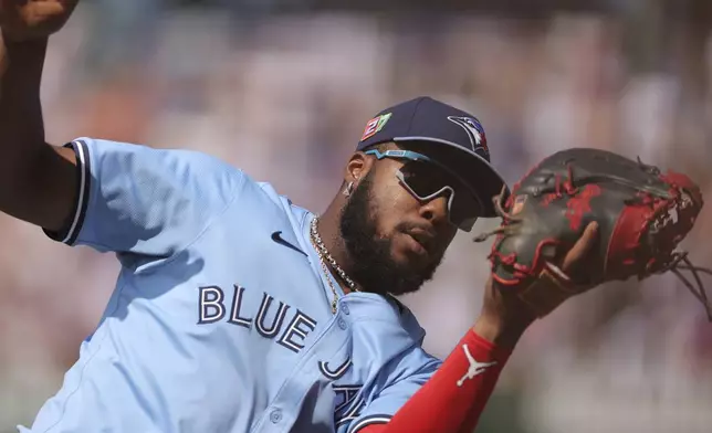 Toronto Blue Jays' Vladimir Guerrero Jr. makes a catch during the seventh inning of a baseball game against the Chicago Cubs, Sunday, Aug. 18, 2024, in Chicago. (AP Photo/Melissa Tamez)