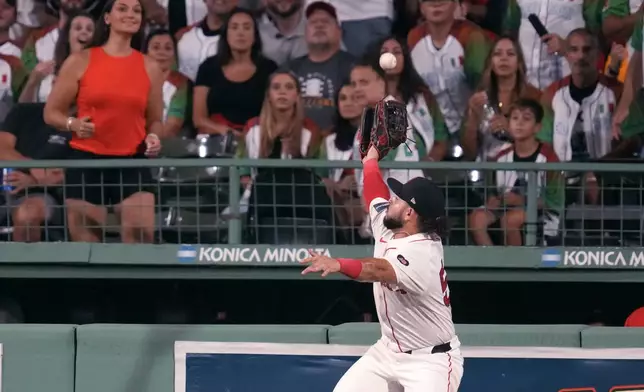 Boston Red Sox outfielder Wilyer Abreu leaps but can't make the catch on a solo home run by Toronto Blue Jays' Will Wagner during the sixth inning of a baseball game at Fenway Park, Tuesday, Aug. 27, 2024, in Boston. (AP Photo/Charles Krupa)