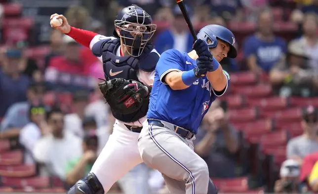 Boston Red Sox catcher Danny Jansen, left, tries to throw out a runner on a steal attempt as Toronto Blue Jays Daulton Varsho, who pinch-hit for Jansen, strikes out during the resumption of the second inning of a baseball game which was delayed due to rain in June, against the Toronto Blue Jays at Fenway Park, Monday, Aug. 26, 2024, in Boston. (AP Photo/Charles Krupa)