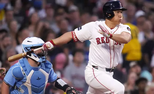 Boston Red Sox's Masataka Yoshida singles during the first inning of a baseball game against the Toronto Blue Jays at Fenway Park, Wednesday, Aug. 28, 2024, in Boston. (AP Photo/Charles Krupa)