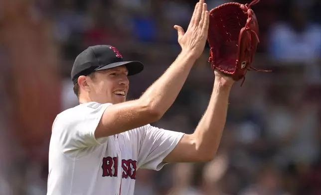 Boston Red Sox pitcher Nick Pivetta applauds after a diving catch by outfielder Wilyer Abreu on a fly ball hit by Toronto Blue Jays's Leo Jimenez during the fifth inning of a baseball game at Fenway Park, Monday, Aug. 26, 2024, in Boston. (AP Photo/Charles Krupa)