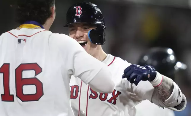 Boston Red Sox's Tyler O'Neill, right, is congratulated by Jarren Duran (16) after his two-run home run in the eighth inning of a baseball game against the Toronto Blue Jays at Fenway Park, Wednesday, Aug. 28, 2024, in Boston. (AP Photo/Charles Krupa)