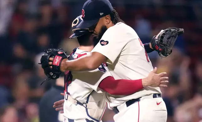 Boston Red Sox pitcher Kenley Jansen, right, is congratulated by catcher Connor Wong after defeating the Toronto Blue Jays 3-0 following a baseball game at Fenway Park, Wednesday, Aug. 28, 2024, in Boston. (AP Photo/Charles Krupa)