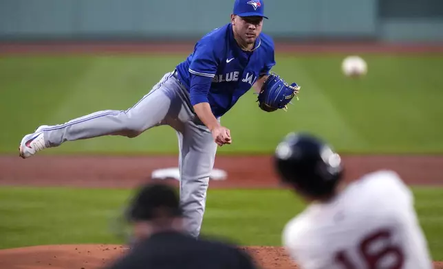 Toronto Blue Jays pitcher Yariel Rodríguez watches Boston Red Sox's Jarren Duran (16) drive a home run ball during the first inning of a baseball game at Fenway Park, Tuesday, Aug. 27, 2024, in Boston. (AP Photo/Charles Krupa)